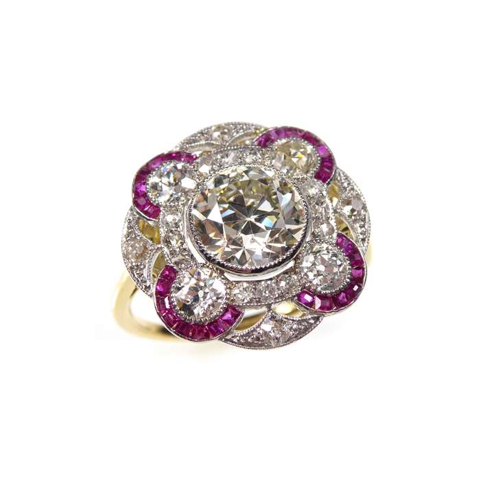 Diamond and ruby circle cluster ring, centred by a principal old round brilliant cut diamond